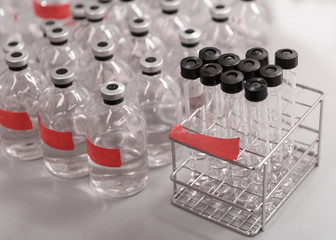 test tubes and bottles in laboratory on white table