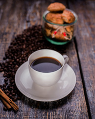 Coffee cup, coffee beans and biscuits, cookies in the shape of heart on wooden background