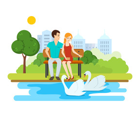 Young couple, relax on bench park near lake with swans.