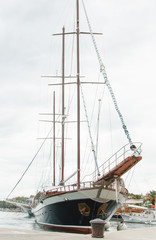 Fototapeta premium Big beautiful wooden yacht with sails moored to the shores of Croatia