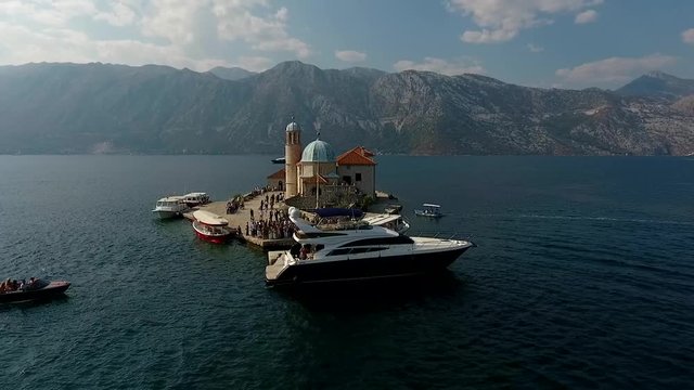 Montenegro, bay air shooting (tiny island with people and many yacht)