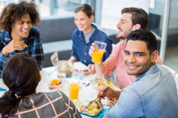 Portrait of happy male executive having breakfast