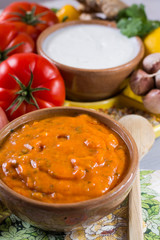 Bowl of spicy vegetable orange Tikka Masala sauce and all the ingredients that go into making it.  Used widely in Asian food.