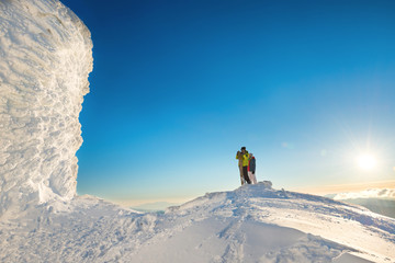 People on the top of the winter mountain