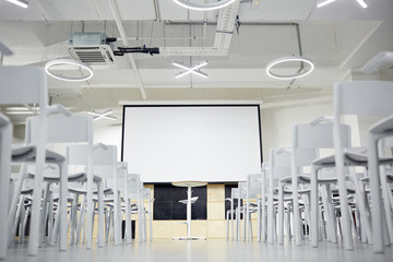 Interior of conference-hall with whiteboard and chairs