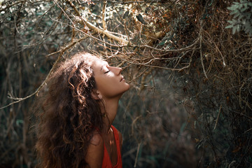 sensitive portrait of beautiful young woman in forest