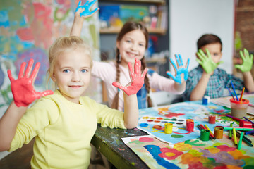 Kids having fun with paint on their palms