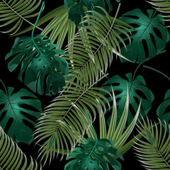 Naklejka na ściany i meble Jungle thickets of tropical palm leaves. Seamless floral pattern. Isolated on a black background. illustration