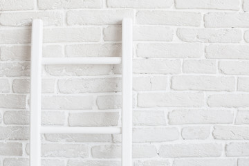 White brick wall with ladder