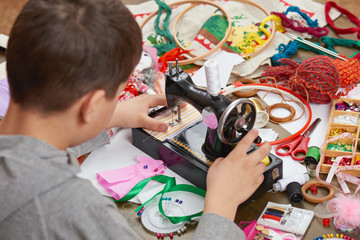 boy tailor learns to sew, job training, handmade and handicraft concept