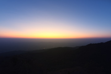 Great sunset above the mountain valley and morning mist.