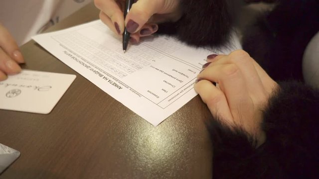Woman fills out questionnaire to receive a discount card
