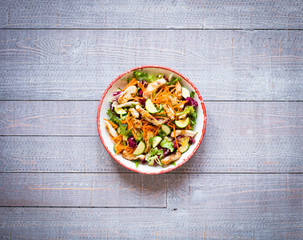 Salad of chicken breast with zucchini and cherry tomatoes, on a wooden background
