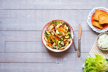 Salad of chicken breast with zucchini and cherry tomatoes, on a wooden background