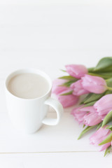 Obraz na płótnie Canvas Mug and Pink tulips on white background