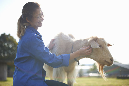 Woman patting goat