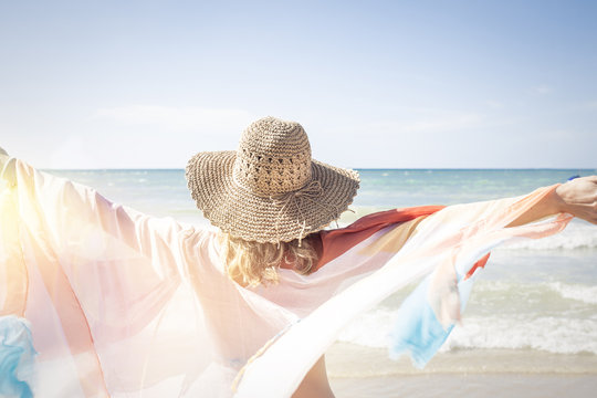 Beautiful woman enjoys the beach