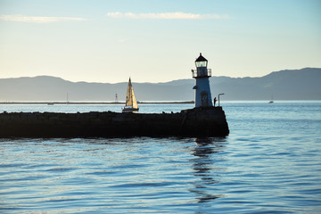 lighthouse and a boat in the marine