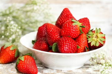 Still life of fresh strawberries on distressed white wooden background, selective focus