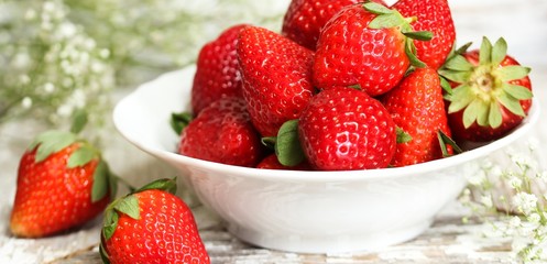 Still life of fresh strawberries on distressed white wooden background, selective focus