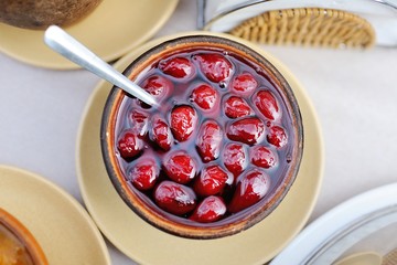 Jam from a dogwood in a white plate close up