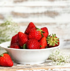 Still life of fresh strawberries on distressed white wooden background, selective focus