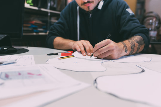 Cropped shot of male metalworker designing in forge office
