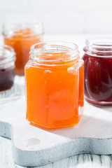 Fototapeta na wymiar assortment of fruit jams, vertical closeup
