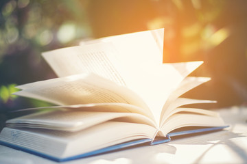 Opened up of book on wooden background.