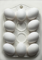  White eggs on the Easter vintage white ceramic dish 
