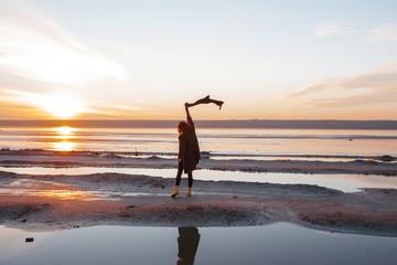 Woman enjoying beach at sunset