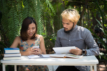 Young couple relaxing at home garden together.