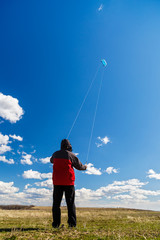 man relaxes in nature To raise a kite