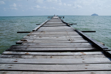 Naklejka na ściany i meble Wooden pier on the sea background