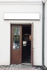 Fototapeta na wymiar Cafe doors opened and modern empty outdoor signage mockup to add company logo