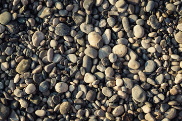 stones and sea,Pebble beach texture,wall pattern of gravel stone,pebbles on the beach as background,Gray sea pebbles on sand background,travel concept,Turkey,Florida,Miami