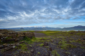 Fototapeta na wymiar Cloudy day at Dyrholaey, Iceland with the blue sky and moving cloud
