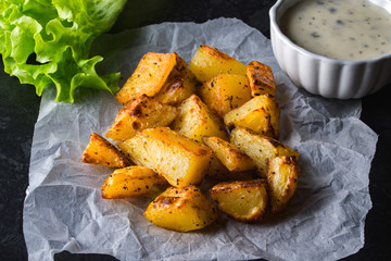 Grilled potatoes served with salad and sauce. Baked potato