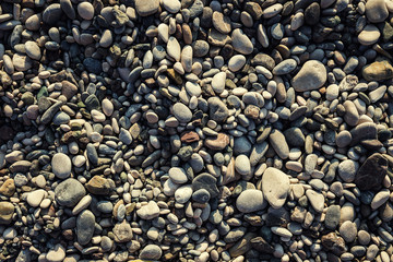 stones and sea,Pebble beach texture,wall pattern of gravel stone,pebbles on the beach as background,Gray sea pebbles on sand background,travel concept,Turkey,Florida,Miami