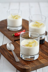 three glasses of tasty panna cotta on the cutting boards
