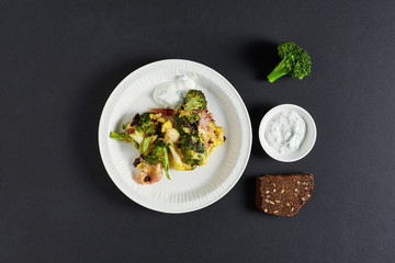 a top view of omelette with bacon and broccoli
