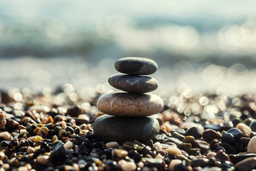 stack of zen stones on beach,zen-like stones on beach and sun in sky. soft focus on bottom,Pyramid of stones on the beach,Zen meditation background - balanced stones stack close up,Pile of pebbles