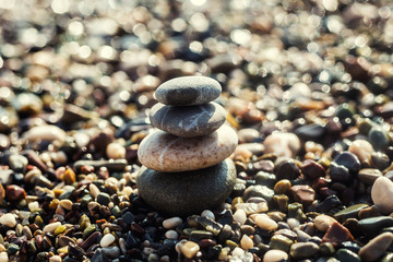 stack of zen stones on beach,zen-like stones on beach and sun in sky. soft focus on bottom,Pyramid of stones on the beach,Zen meditation background - balanced stones stack close up,Pile of pebbles