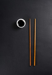 Chopsticks with soy sauce in a small cup