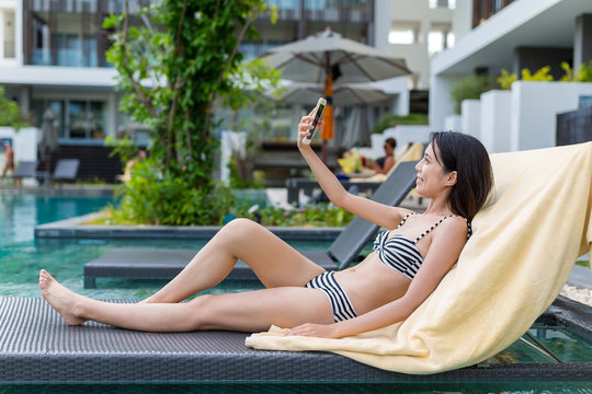Woman taking selfie in swimming pool