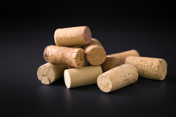 Many wine corks on a dark background