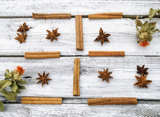 Cinnamon, anise and saffron on a white wooden surface