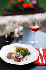 Grilled meat and steamed vegetables on the table