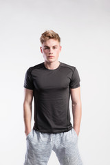 Fototapeta premium Handsome fitness man in black t-shirt and shorts, studio shot.