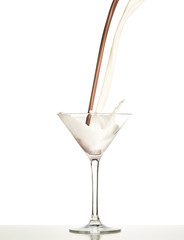 macro shoot with hot chocolate falling in glass on white in studio